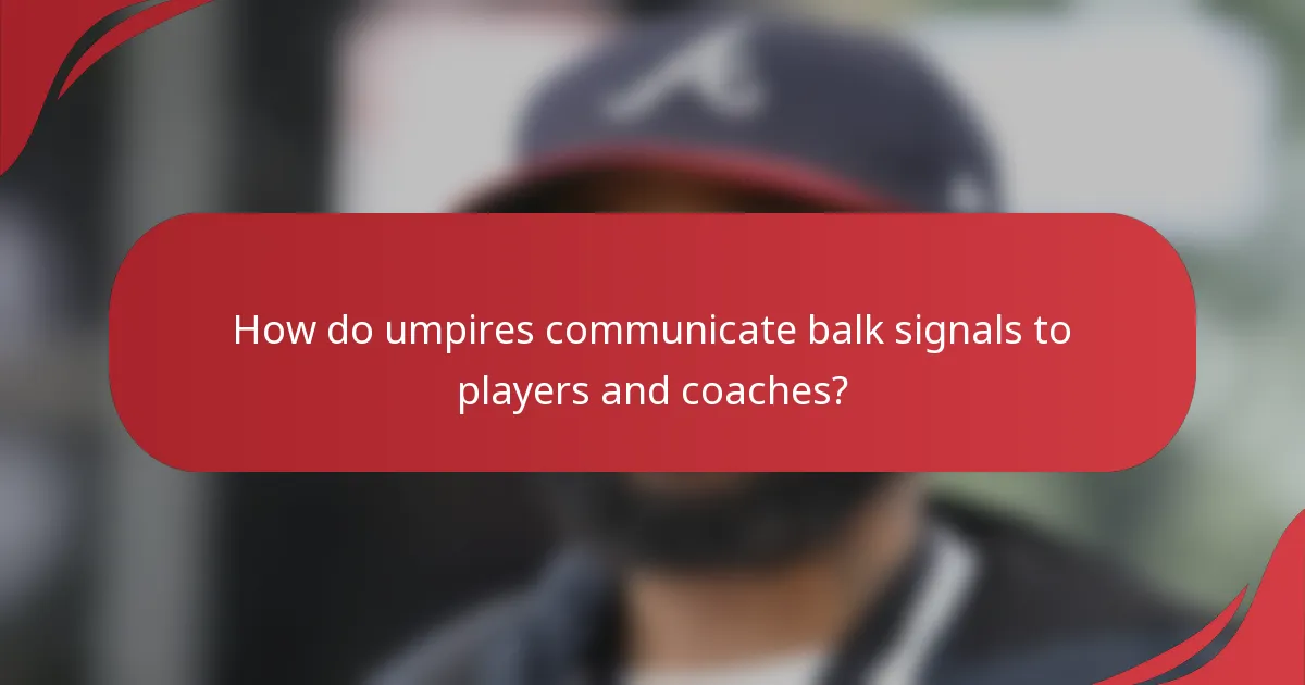 How do umpires communicate balk signals to players and coaches?