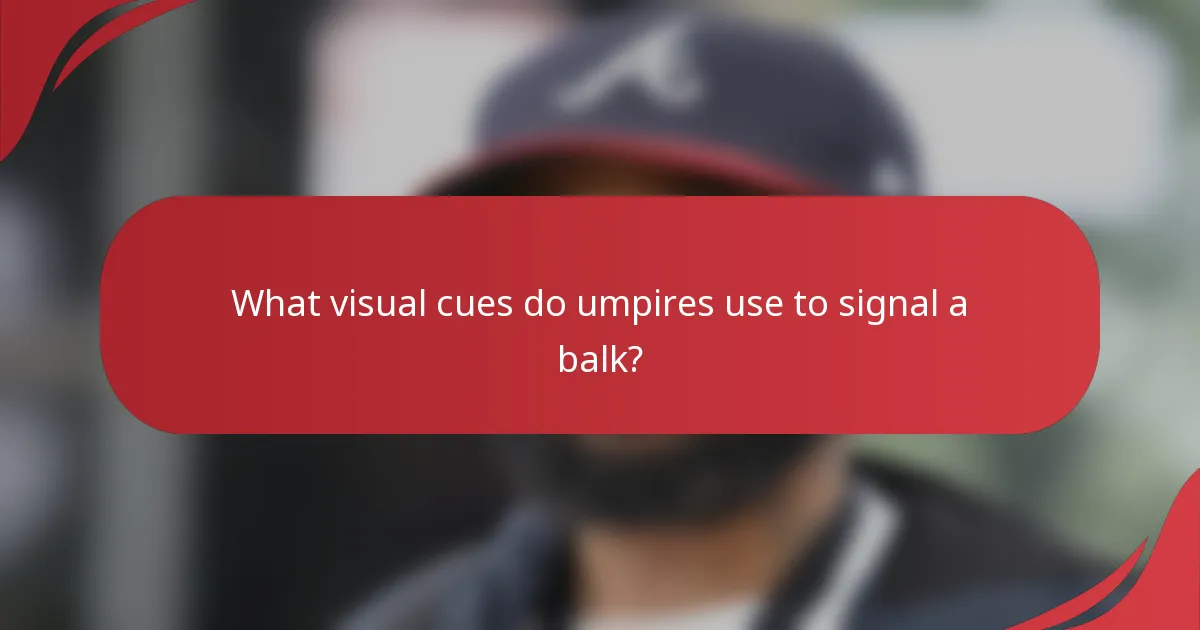What visual cues do umpires use to signal a balk?